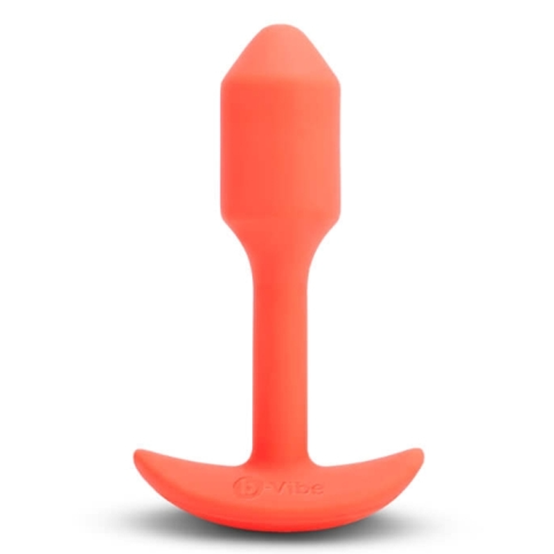 Small orange vibrating snug plug with a tapered tip, weighted for deep stimulation.